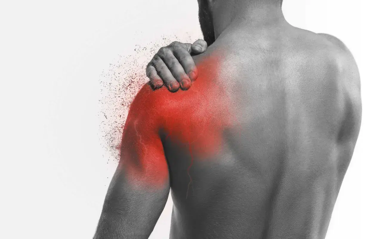 Uomo con mano sulla spalla, evidenziata in rosso, che simboleggia il dolore alla scapola quando respiro. Effetto di frammentazione.